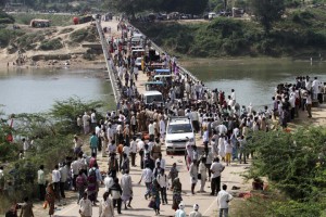 People cross a bridge after a stampede near Ratangarh temple in Datia