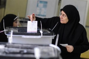 A woman casts her vote at a polling centre during a referendum on Egypt's new constitution in Cairo