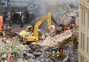 Heavy equipment removes rubble from the site of three collapsed buildings in downtown Rio de Janeiro.