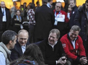 Russia's President Putin sits next to to USOC chairman Probst as he visits Team USA House at U.S. Olympic Committee headquarters in the Olympic Park during the Sochi 2014 Winter Olympics Games