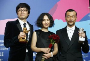 Actor Liao Fan director Diao Yinan and producer Qu pose with Silver Bear for Best Actor and Golden Bear for Best film after awards ceremony of 64th Berlinale International Film Festival in Berlin