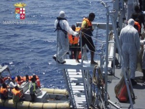 Handout picture of migrants walking aboard the Italian navy ship Scirocco during a rescue operation about 40 nautical miles off the coast of Libya