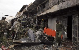 Security personnel attempt to retrieve bodies from wreckage of a cargo plane that crashed into a commercial building on outskirts of Nairobi