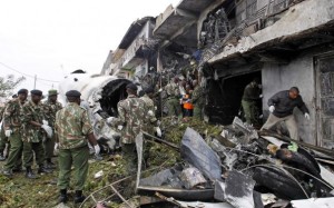Security personnel attempt to retrieve bodies from wreckage of a cargo plane that crashed into a commercial building on outskirts of Nairobi