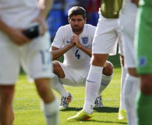England's Gerrard squats on the pitch after their 2014 World Cup Group D soccer match against Costa Rica at the Mineirao stadium in Belo Horizonte