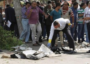 Forensic workers and policemen carry out investigations at the scene of a bomb blast in Cairo