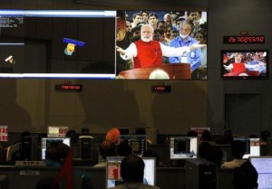 ISRO scientists and engineers watch PM Modi on screens after India's Mars orbiter successfully entered at their Spacecraft Control Center in Bangalore