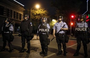 Police officers block an intersection during a protest after a vigil in St. Louis, Missouri