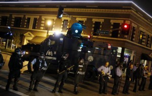 Police officers block an intersection during a protest after a vigil in St. Louis, Missouri