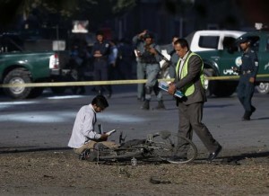 Afghan security personnel investigate at the site of a suicide attack in Kabul