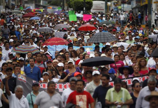 Students, teachers and family members participate in a march in Acapulco