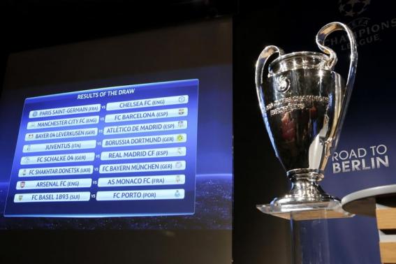 A screen shows the results of the draw for the Champions League round of 16 soccer matches at the UEFA headquarters in Nyon