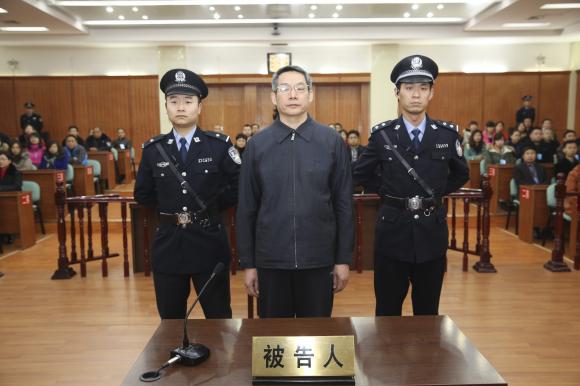 Liu Tienan, the former deputy head of China's top planning agency, stands during his verdict at a court in Langfang, Hebei province