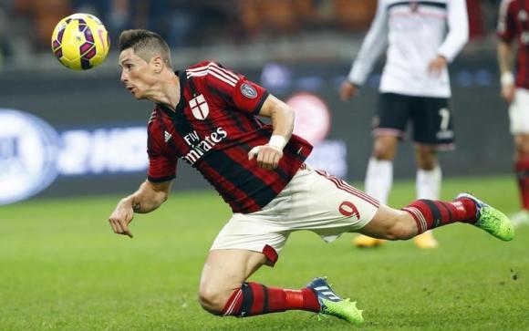 AC Milan's Fernando Torres heads the ball during their Serie A soccer match against Palermo at San Siro stadium in Milan