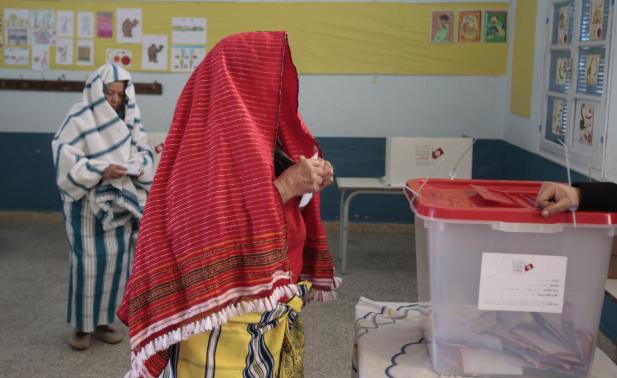 Woman casts her ballot at a polling station during an election in Sousse