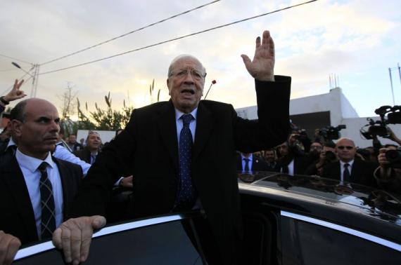 Essebsi, leader of Tunisia's secular Nidaa Tounes party and a presidential candidate, gestures after casting his vote at a polling station in Tunis
