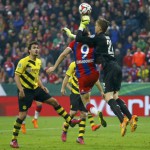 Bayern Munich's Lewandowski is fouled by Borussia Dortmund's goalkeeper Langerak during German Cup semi-final soccer match in Munich