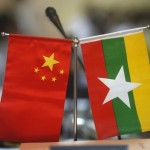 Myanmar and Chinese national flags are seen on a table during the opening ceremony of opening office of Pyithau Hluttaw Commission for Assessment of Legal Affairs and Special Issues office, in Yangon