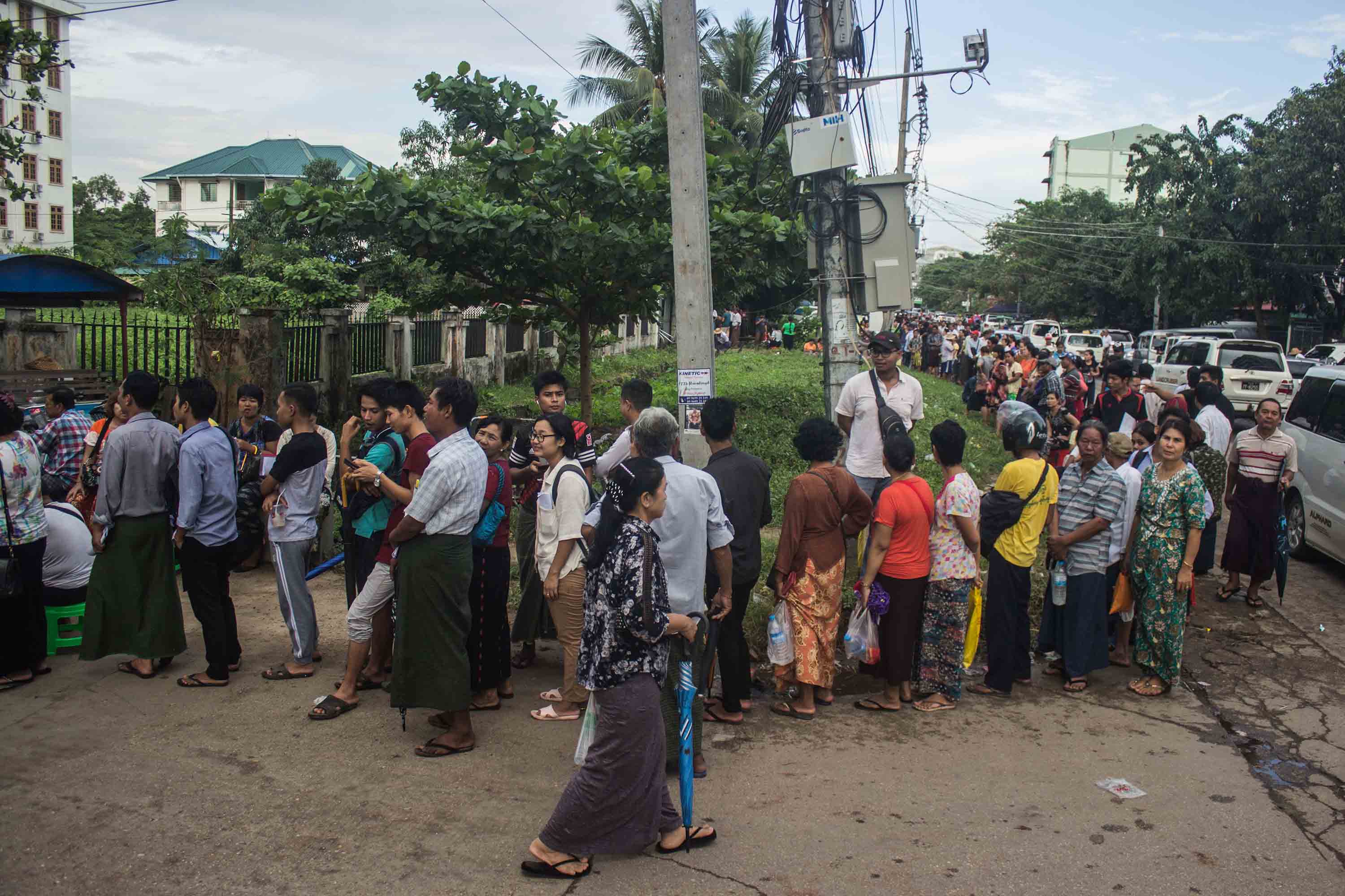 ရန်ကုန်အရှေ့ပိုင်းခရိုင်စုပေါင်းရုံးရှေ့တွင် မြေဝယ်ခွင့်ရရန် တန်းစီစောင့်နေသူများ (ဓာတ်ပုံ)