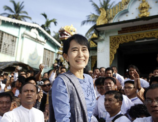 Suu Kyi, leader of Myanmar's democratic opposition, smiles to supporters before leaving Shwemawdaw Pagoda at Bago