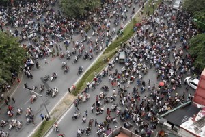 People travel along a street in Hanoi