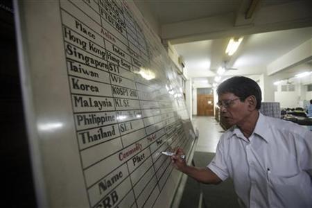 An office staff writes on a white board at the Myanmar Securities Exchange Centre in Yangon